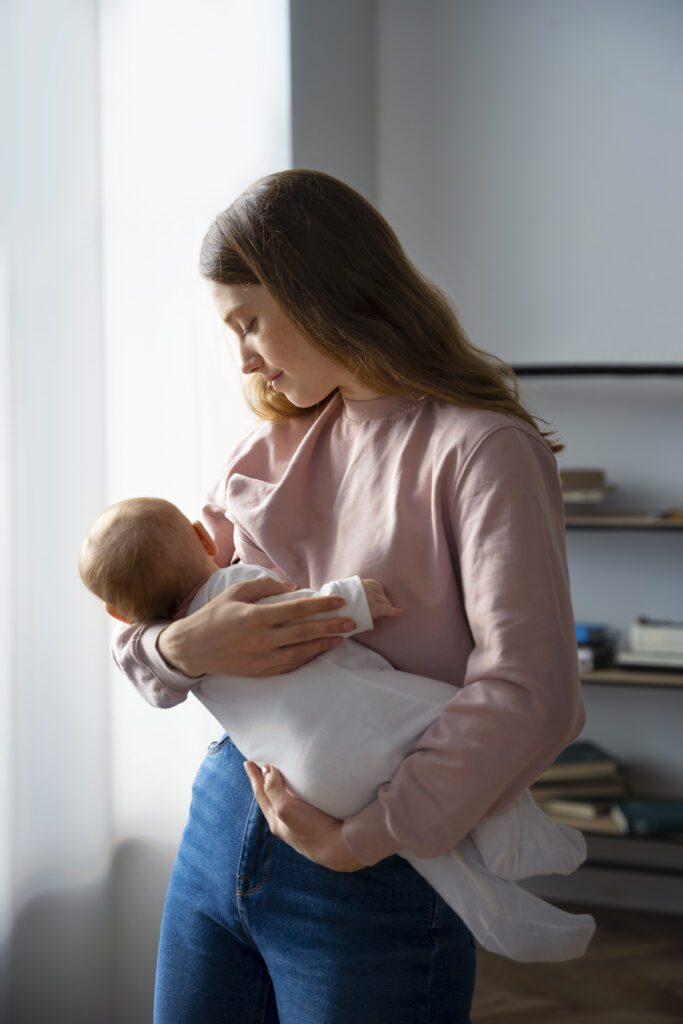 side view mother with cute newborn 2